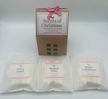 Packaged candles labeled 'Snow Angel', 'Mulled Wine', and 'White Christmas' with a 'Scents of Christmas' box.
