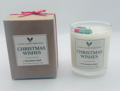 Candle and packaging with 'Christmas Wishes' text by The Aroma Lodge on a white background