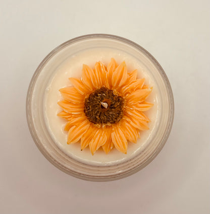 Candle with a sunflower design on a white background
